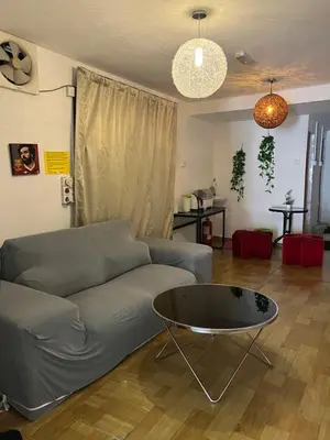 a living room with a couch and a table at Comfortable Stay in Ayer Itam