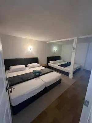 two beds in a room with two bunk beds at Comfortable Stay in Ayer Itam