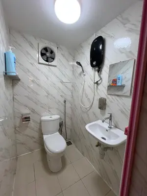 a bathroom with a toilet and a sink at Comfortable Stay in Ayer Itam