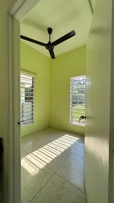 an empty room with a ceiling fan and a window at Baitul Ilmi Homestay in Kuala Kangsar