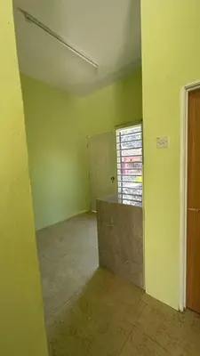 an empty room with green walls and a window at Baitul Ilmi Homestay in Kuala Kangsar