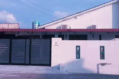 a white building with a gate and a bridge at Y.s.a Homestay(100mbps Wifi) in Ipoh