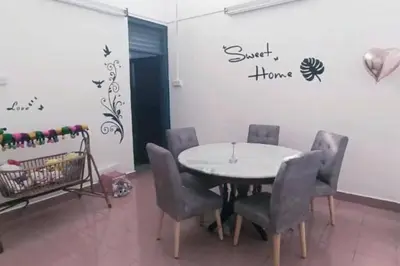 a dining room with a white table and chairs at Y.s.a Homestay(100mbps Wifi) in Ipoh