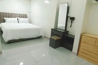 a bedroom with a bed and a dresser and a mirror at Y.s.a Homestay(100mbps Wifi) in Ipoh