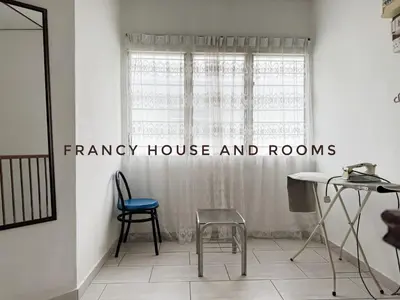 a room with a table and chairs and a window at Nanyang Style Home In Ipoh in Ipoh