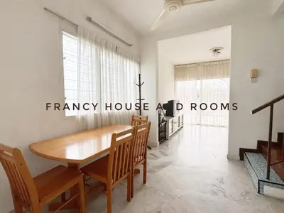 a dining room with a wooden table and chairs at Nanyang Style Home In Ipoh in Ipoh