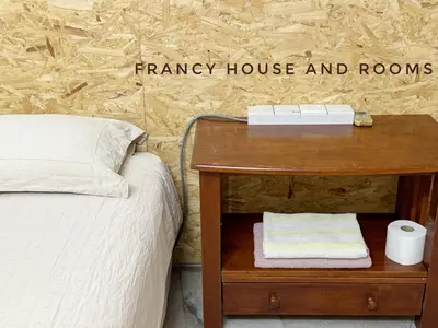 a bedroom with a bed and a wooden table with a nightstand at Nanyang Style Home In Ipoh in Ipoh