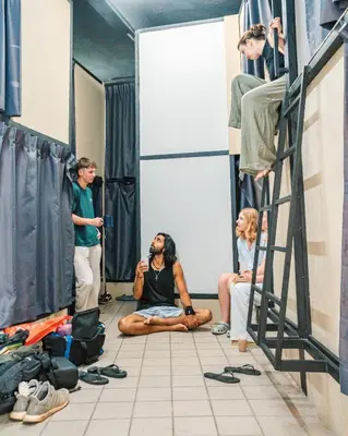 a group of people standing in a dressing room at KITA Hostel in George Town