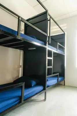 a bunk bed in a room with blue bunk beds at KITA Hostel in George Town