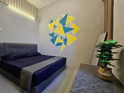 a bedroom with a bed and a painting on the wall at KITA Hostel in George Town