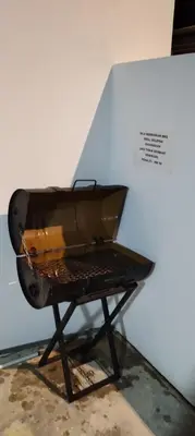 a grill sitting on a stand in a room at MiAmorHomestay in Gua Sai