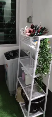 a shelf with a plant next to a washing machine at MiAmorHomestay in Gua Sai