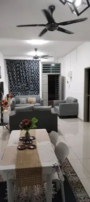 a living room with a couch and a table at MiAmorHomestay in Gua Sai
