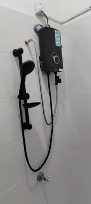 a camera on the wall of a shower in a bathroom at MiAmorHomestay in Gua Sai
