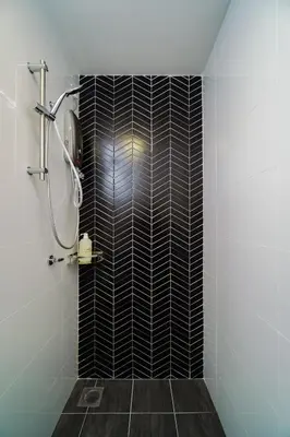 a bathroom with a shower with black and white tile at L13 Cozy Corner The Horizon Ipoh in Ipoh