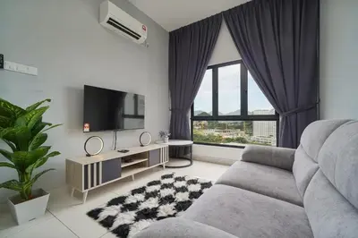 a living room with a couch and a flat screen tv at L13 Cozy Corner The Horizon Ipoh in Ipoh