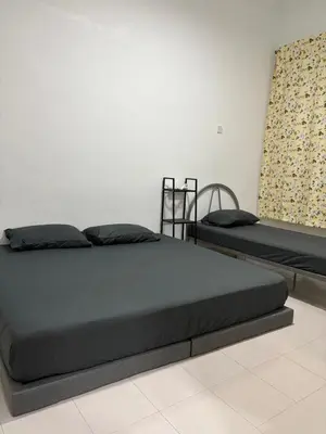 a bedroom with two beds in a room at Bidor Homestay in Bidur