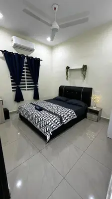 a bedroom with a large bed in a room at Luna De Haus Homestay in Sungai Petani
