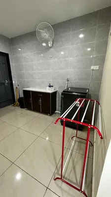 a kitchen with a red stool in a room at Luna De Haus Homestay in Sungai Petani