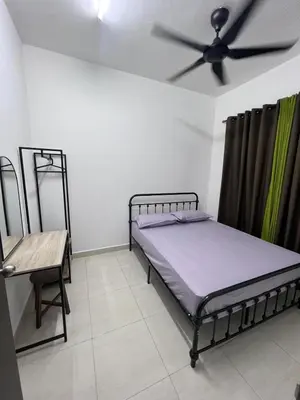 a bedroom with a bed and a ceiling fan at berTIGA Homestay Bertam in Kepala Batas