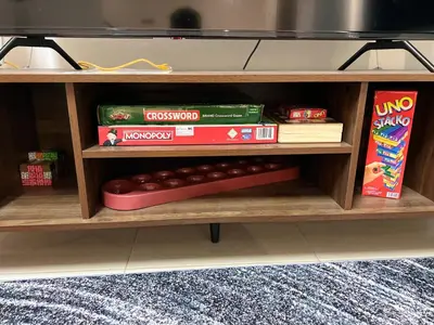 a wooden shelf with books and food on it at berTIGA Homestay Bertam in Kepala Batas