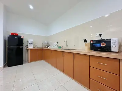 a kitchen with a black refrigerator and brown cabinets at 10Pax BM\u5927\u5c71\u811a Alma Single storey Semi-D 5-minute To Aeon Mall in Bukit Mertajam