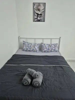 a stuffed animal is laying on a bed at Syaf Homestay in Lunas
