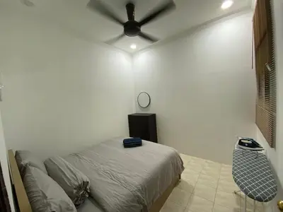 a bedroom with a bed and a ceiling fan at Saujana Number 5 in Gua Sai