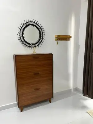 a dresser in a room with a mirror on the wall at Saujana Number 5 in Gua Sai