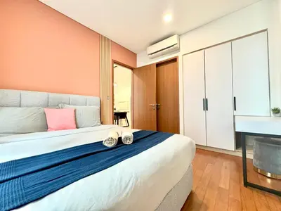 a bedroom with a large bed with shoes on it at Sky Suites Peaches 2BR nearby KLCC in Gua Sai