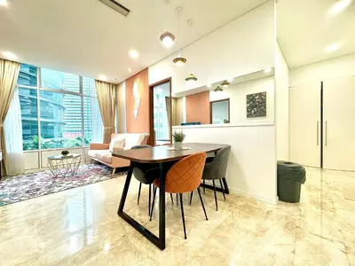 a living room with a table and chairs in it at Sky Suites Peaches 2BR nearby KLCC in Gua Sai