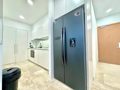 a large blue refrigerator in a kitchen with white cabinets at Sky Suites Peaches 2BR nearby KLCC in Gua Sai