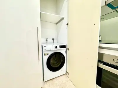 a washer and dryer in a small room at Sky Suites Peaches 2BR nearby KLCC in Gua Sai