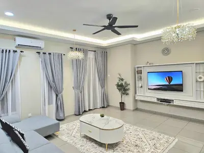 a living room with a couch and a tv at Adam Homestay in Gua Sai