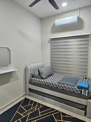 a large bed in a room with a tv at Adam Homestay in Gua Sai