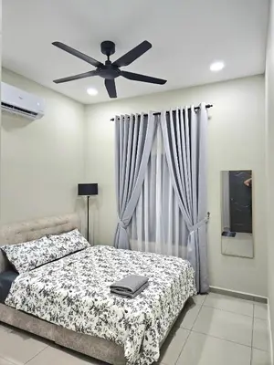 a bedroom with a bed and a ceiling fan at Adam Homestay in Gua Sai