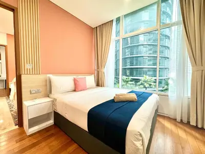 a bedroom with a bed with a large window at Sky Suites Peaches 2BR Nearby KLCC in Gua Sai