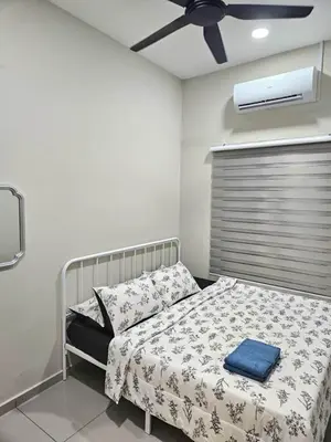 a bedroom with a bed and a ceiling fan at Adam Homestay in Gua Sai