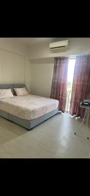 a bedroom with a bed and a window at By The Sea in Batu Ferringhi
