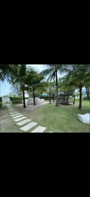 a park with palm trees and a walk way at By The Sea in Batu Ferringhi