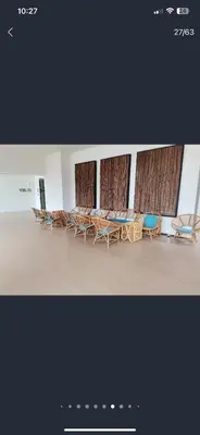 a group of chairs and tables in a room at By The Sea in Batu Ferringhi