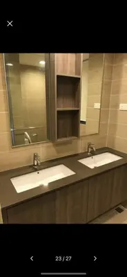 a bathroom with two sinks and a large mirror at By The Sea in Batu Ferringhi