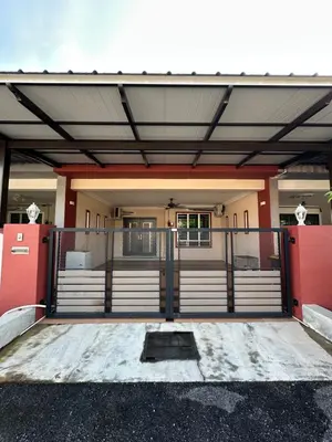 a front entrance to a building with a gate at Ahnaf Guesthouse in Sitiawan