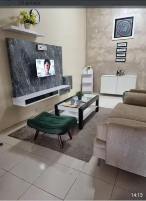 a living room with a couch and a table at Alisa Homestay in Lunas