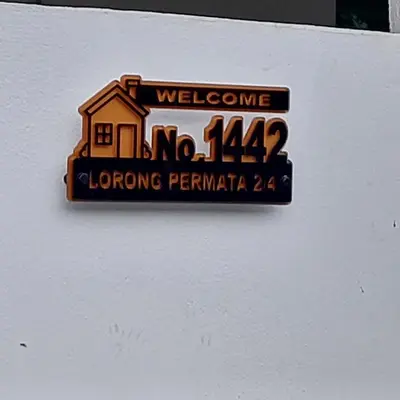 a sign on a wall with a house on it at Alisa Homestay in Lunas