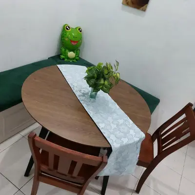 a table with a green frog sitting on top of it at Alisa Homestay in Lunas