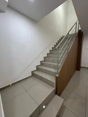 a staircase in a building with a stair case at Casa De Olive Islamic Only in Kampong Batu Lapan