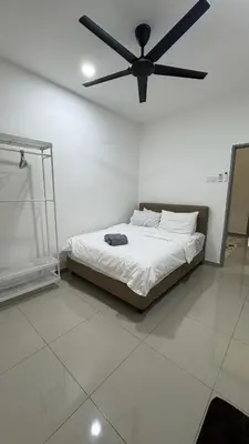a bedroom with a bed with a ceiling fan at Casa De Olive Islamic Only in Kampong Batu Lapan