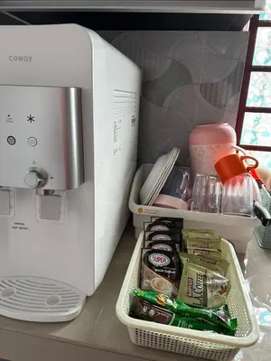 a refrigerator filled with food next to a microwave at Dlaili Homestay in Tanjung Karang
