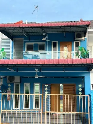 a blue house with a balcony at Dlaili Homestay in Tanjung Karang